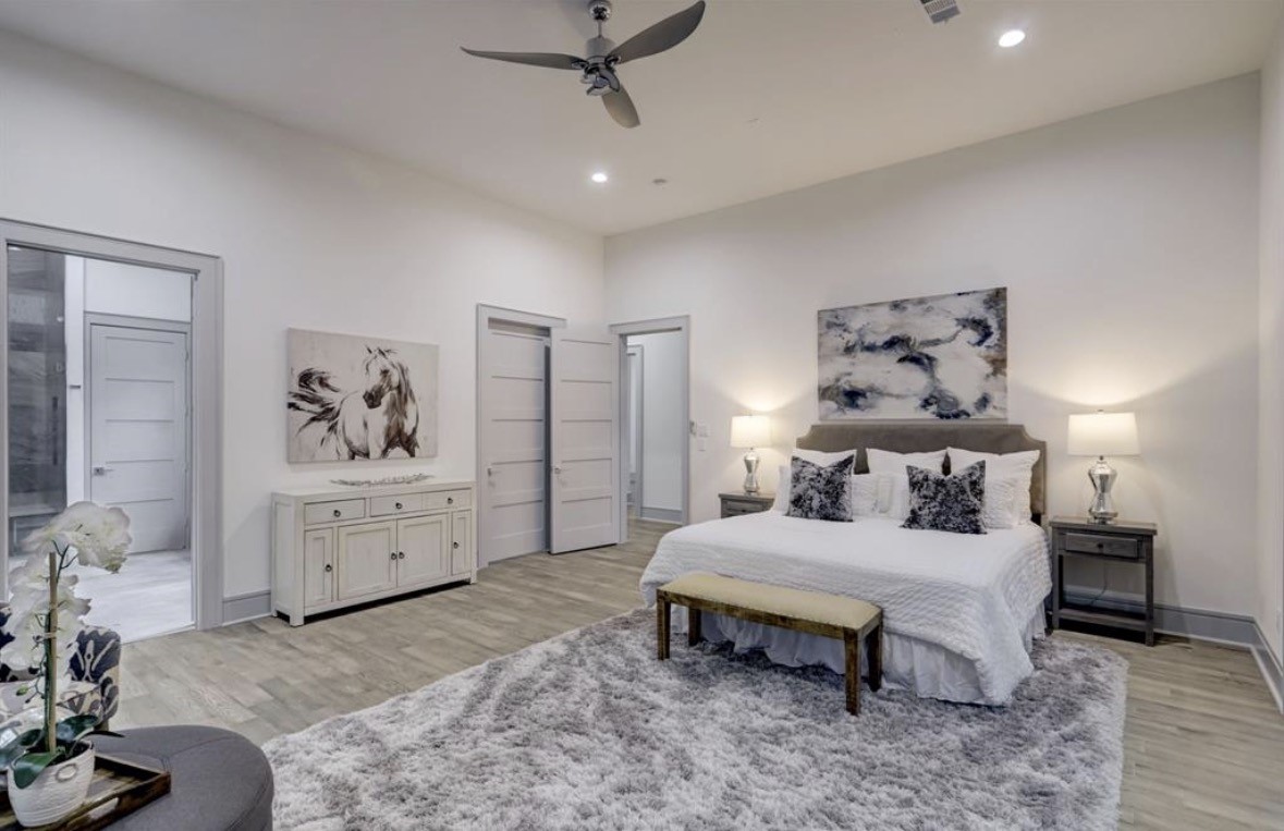 1709 Reverse Street Houston, TX 77055 - Photo 20 of 29 a bedroom with a bed and wooden floor