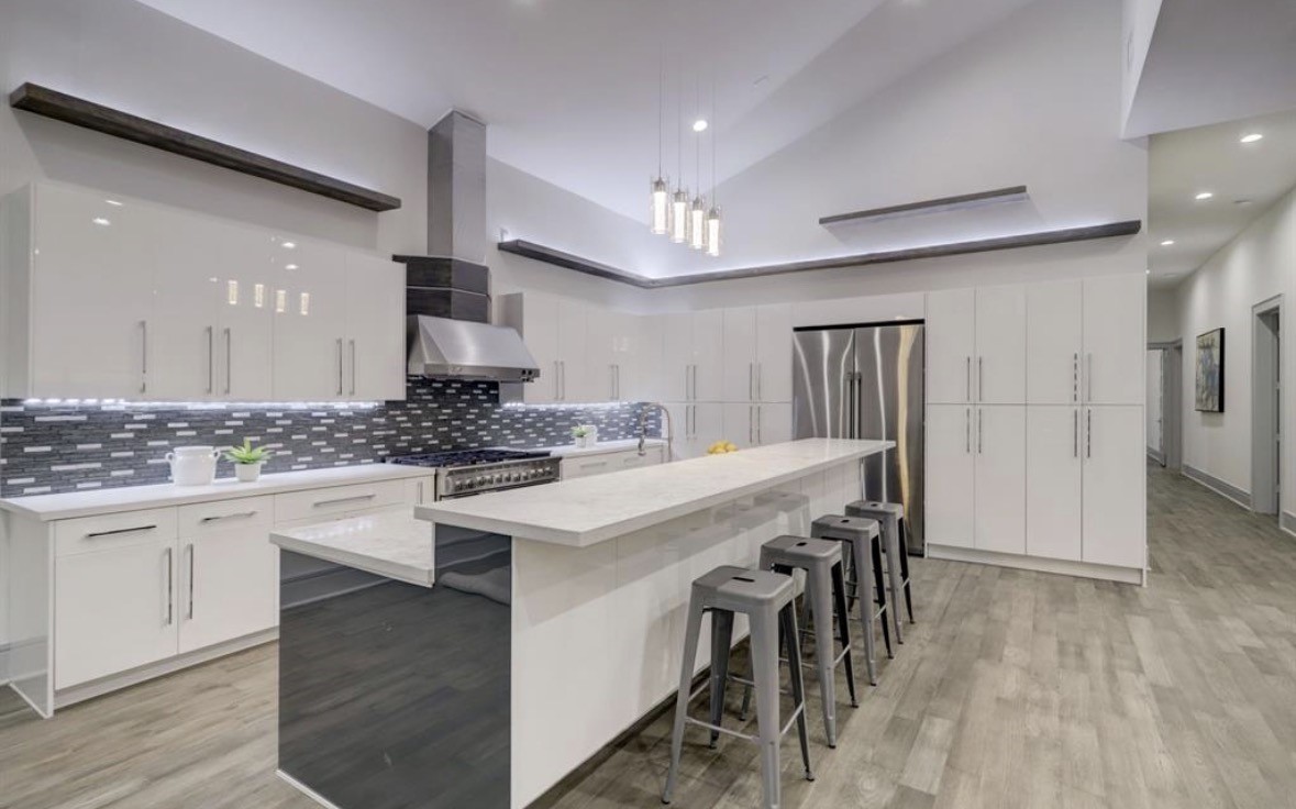 1709 Reverse Street Houston, TX 77055 - Photo 4 of 29 a large white kitchen with a sink and cabinets