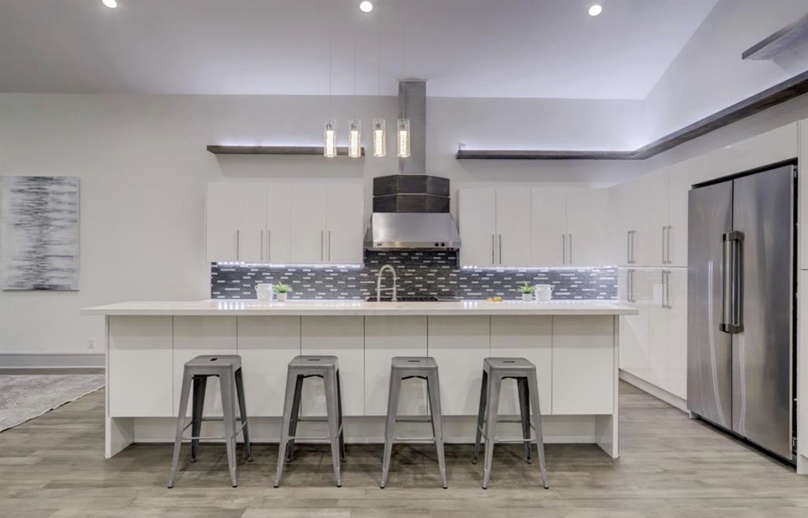 1709 Reverse Street Houston, TX 77055 - Photo 6 of 29 a kitchen with granite countertop white cabinets and stainless steel appliances