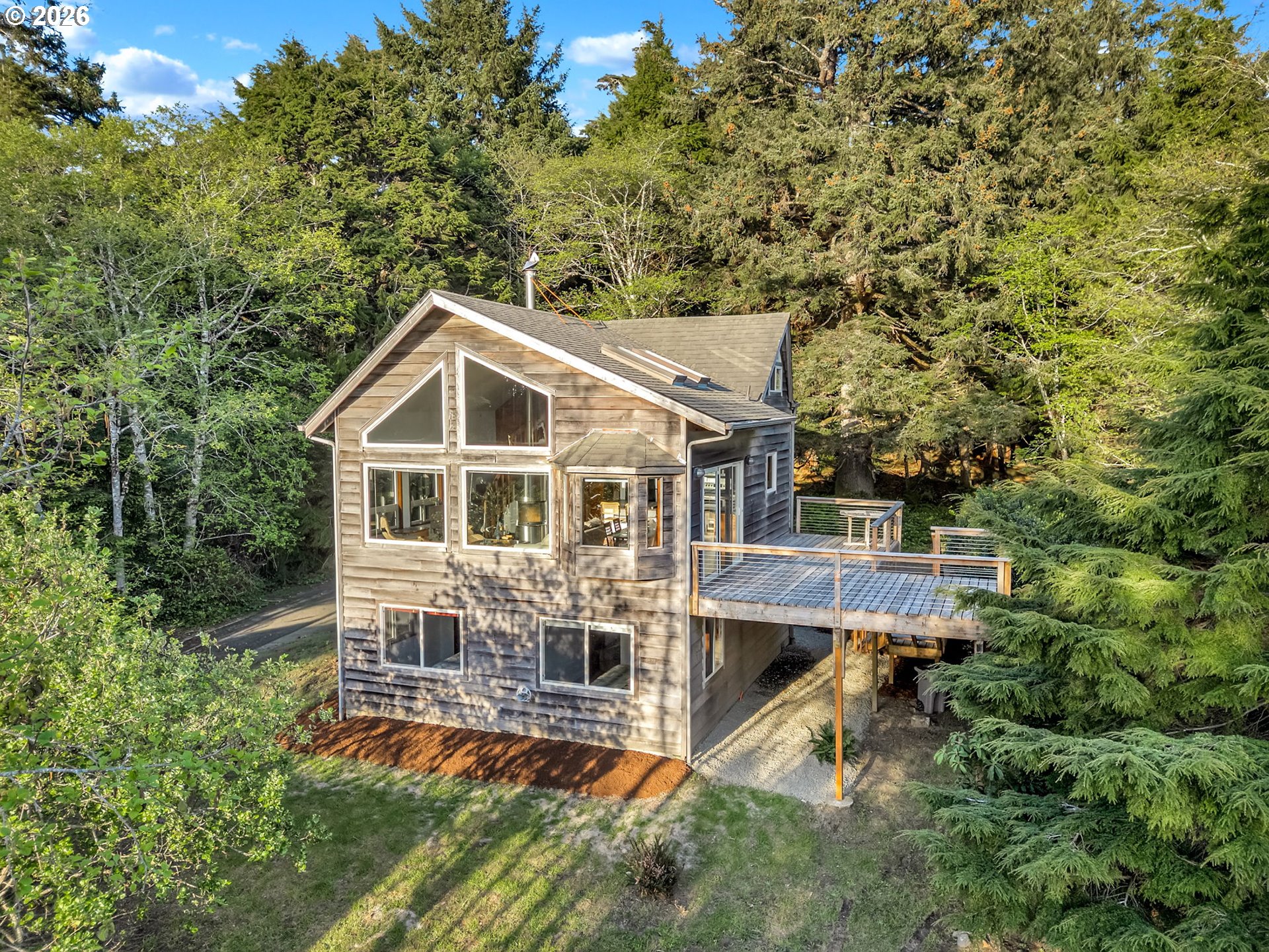 80248 Woodland Heights Road Arch Cape, OR 97102 - Photo 1 of 33 an aerial view of a house with a yard