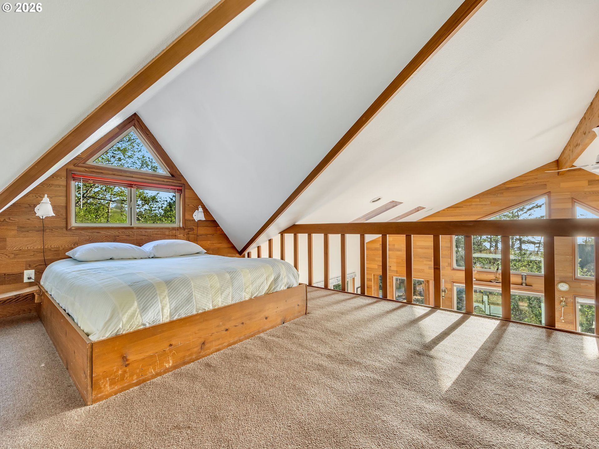 80248 Woodland Heights Road Arch Cape, OR 97102 - Photo 21 of 33 a bed sitting in a room next to a large window