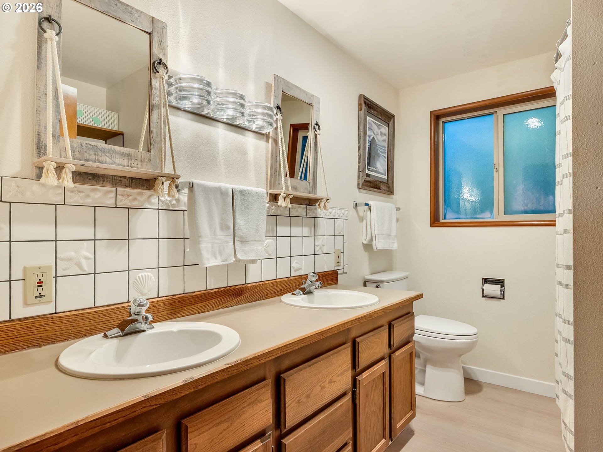 80248 Woodland Heights Road Arch Cape, OR 97102 - Photo 23 of 33 a bathroom with a sink a toilet and mirror