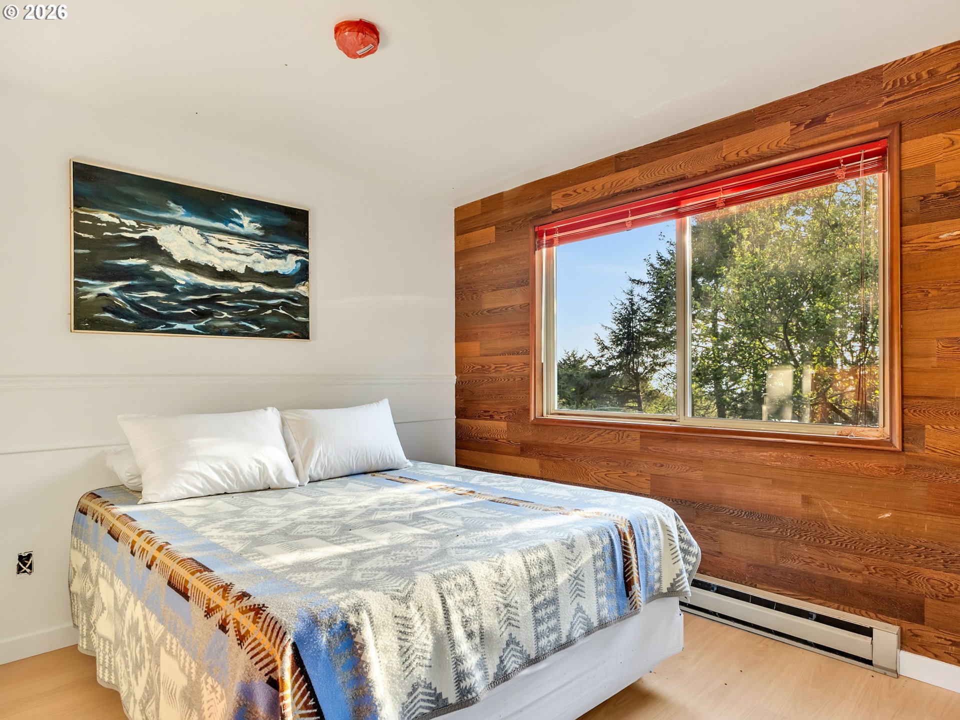 80248 Woodland Heights Road Arch Cape, OR 97102 - Photo 24 of 33 a bedroom with a bed and a large window