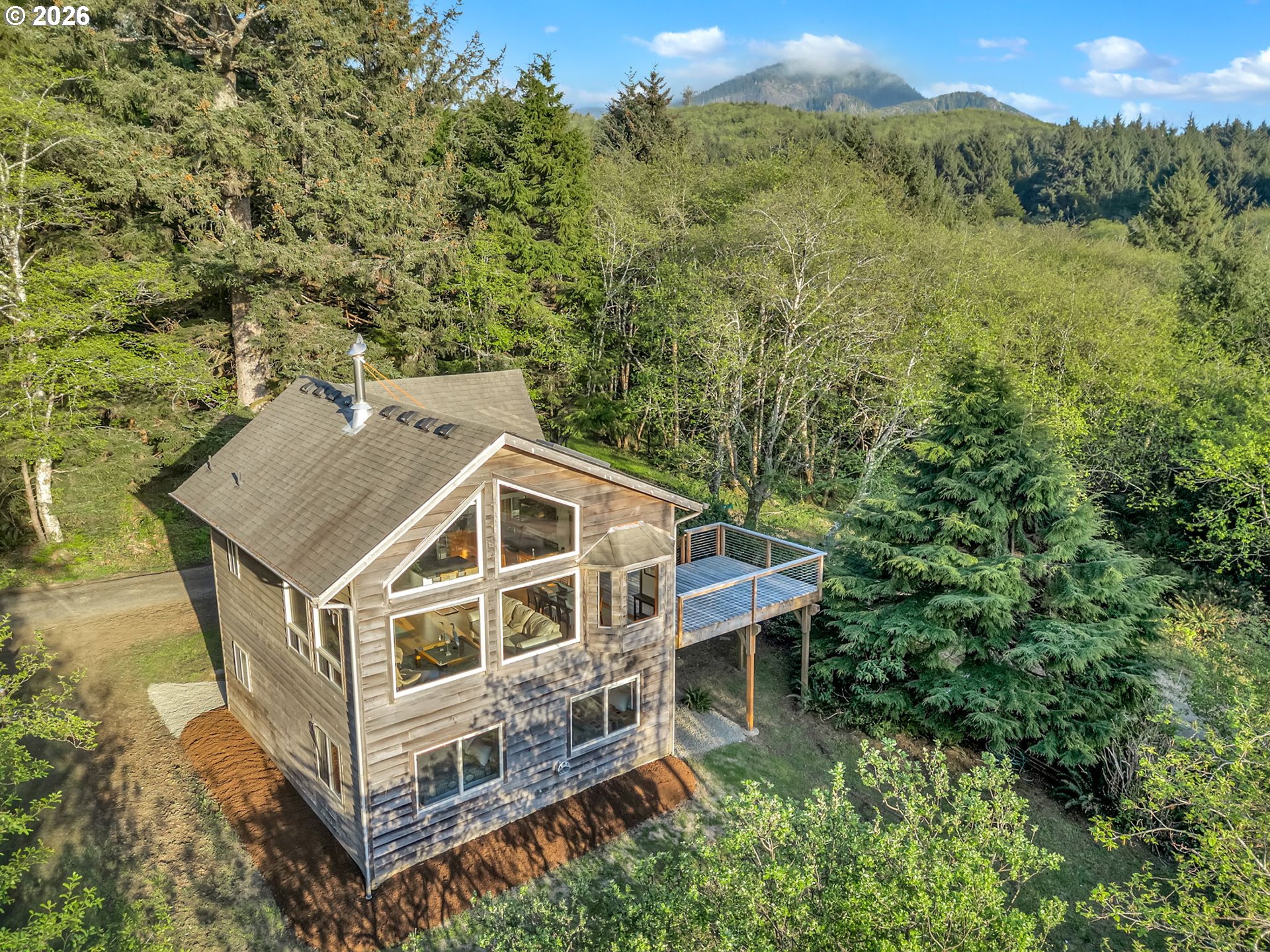 80248 Woodland Heights Road Arch Cape, OR 97102 - Photo 27 of 33 an aerial view of a house with a yard