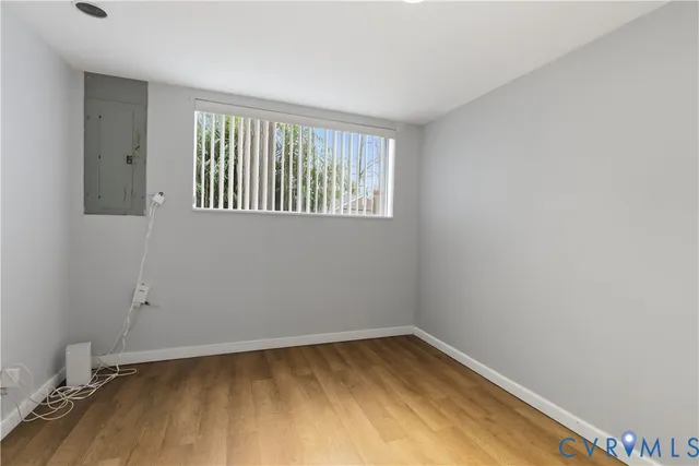 wooden floor in an empty room with a window