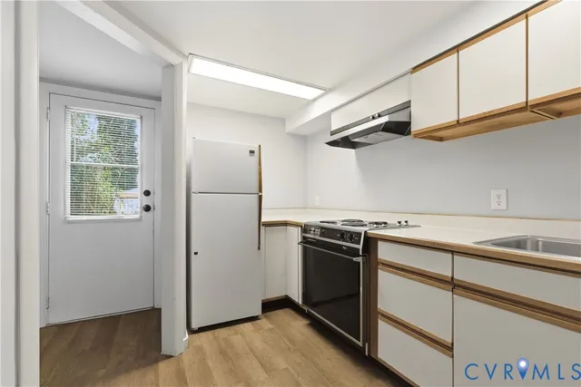 a kitchen with stainless steel appliances granite countertop a refrigerator and a stove