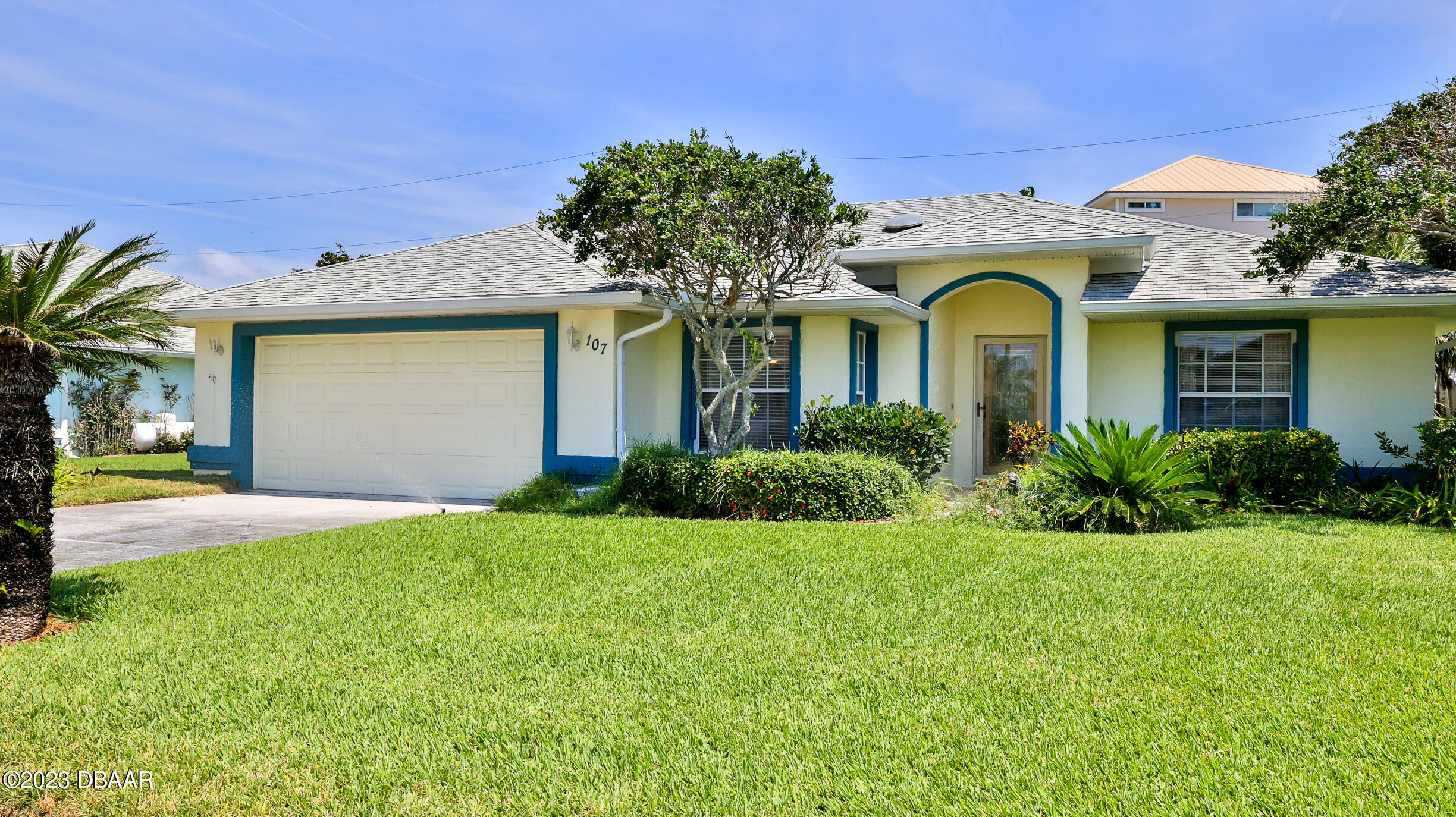 a front view of a house with a garden
