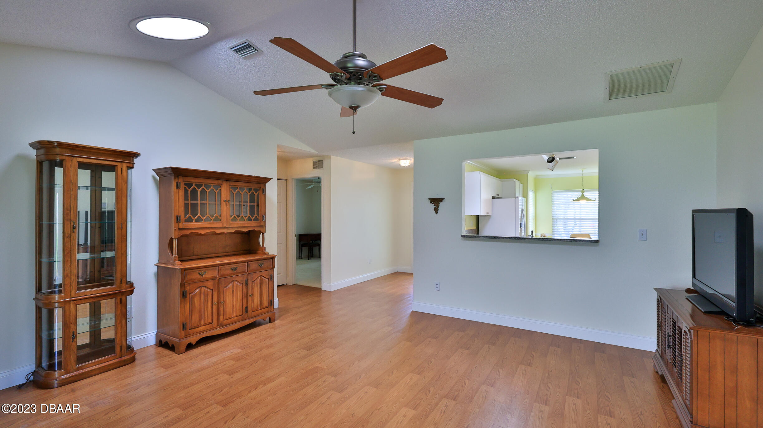 107 Sandpiper Ridge Drive Ormond Beach, FL 32176 - Photo 13 of 53 a view of a livingroom with wooden floor and a ceiling fan