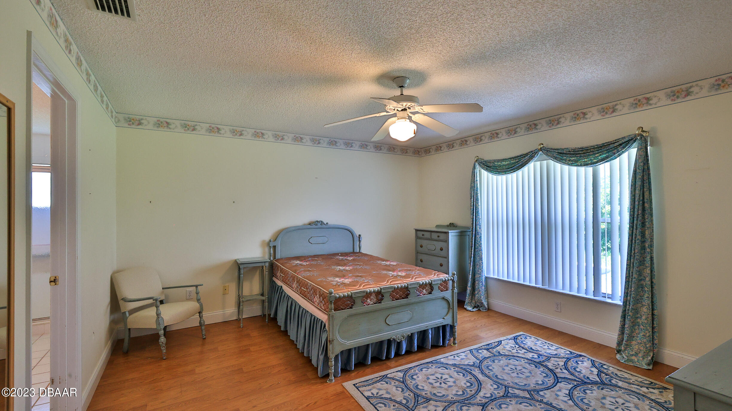107 Sandpiper Ridge Drive Ormond Beach, FL 32176 - Photo 15 of 53 a bedroom with a bed and a chandelier