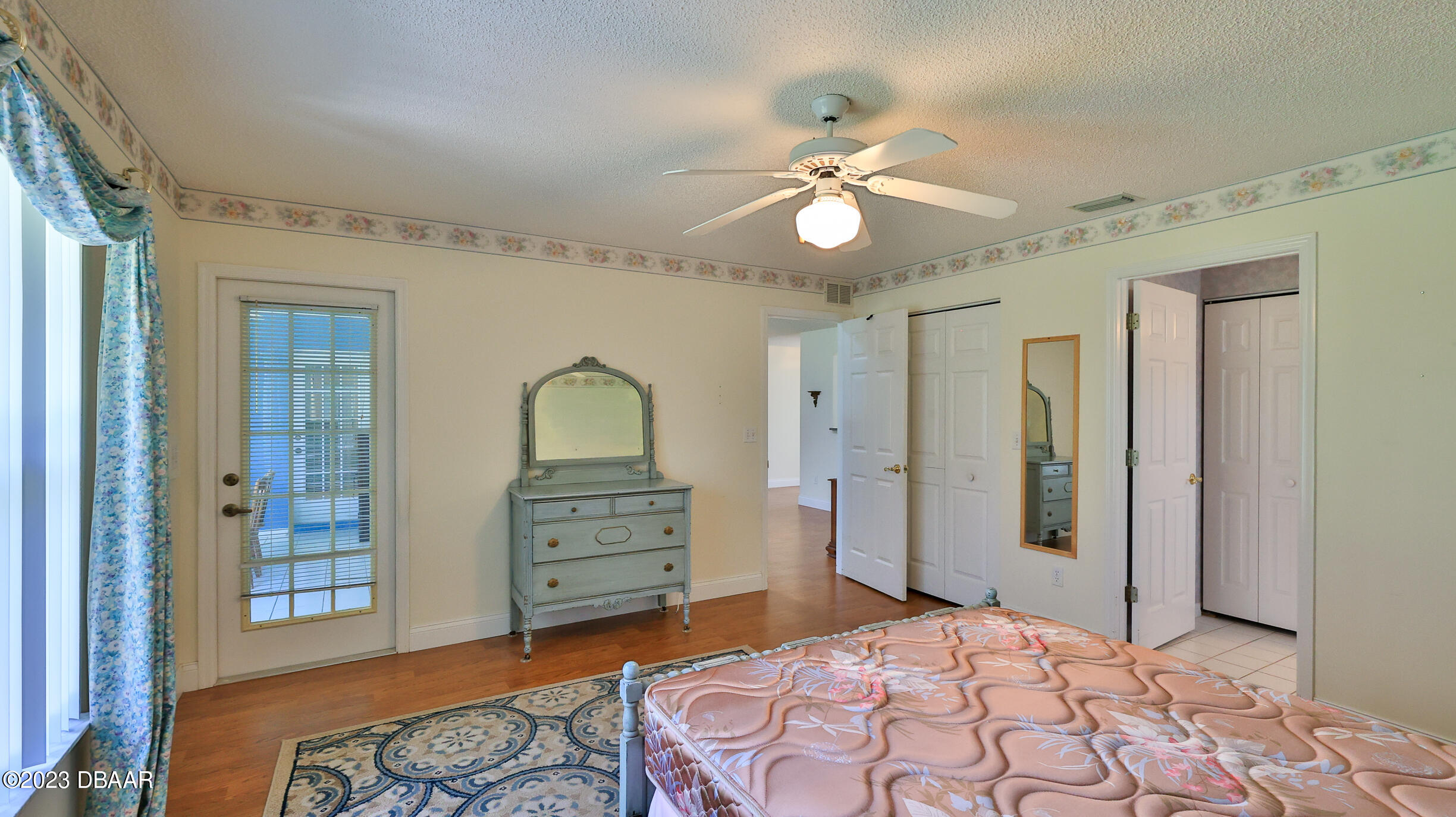 107 Sandpiper Ridge Drive Ormond Beach, FL 32176 - Photo 16 of 53 a bedroom with a bed and a chandelier
