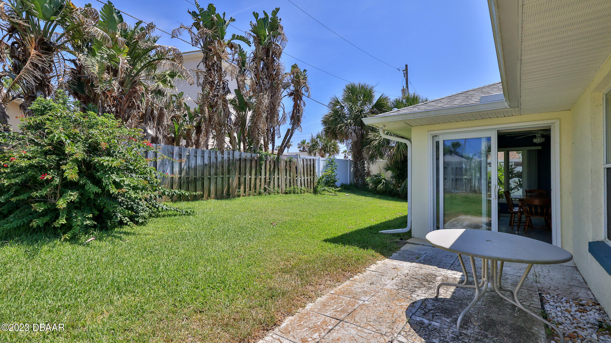 107 Sandpiper Ridge Drive Ormond Beach, FL 32176 - Photo 29 of 53 a view of a chair and table in backyard of the house