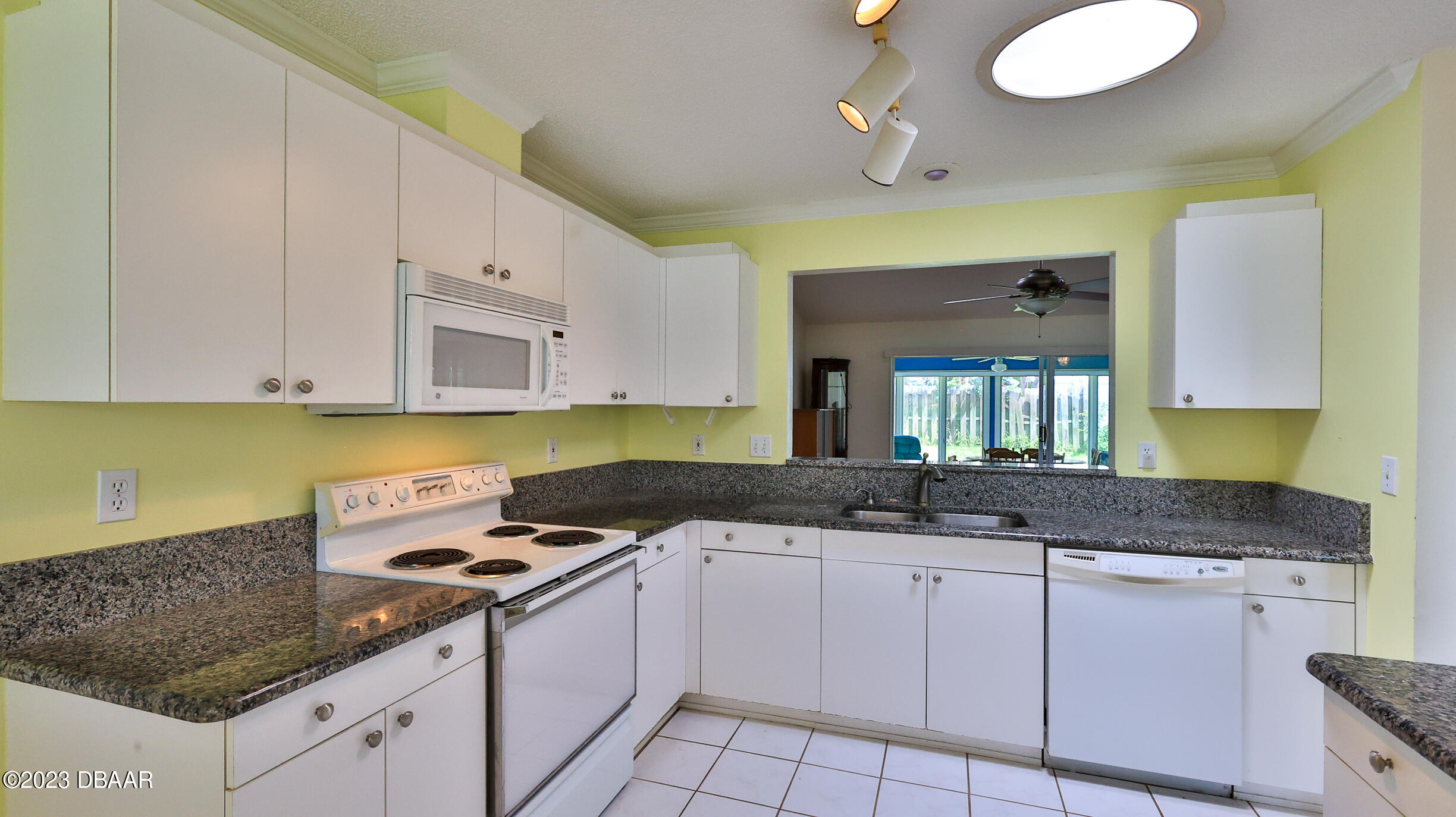 107 Sandpiper Ridge Drive Ormond Beach, FL 32176 - Photo 8 of 53 a kitchen with granite countertop a sink a stove and cabinets