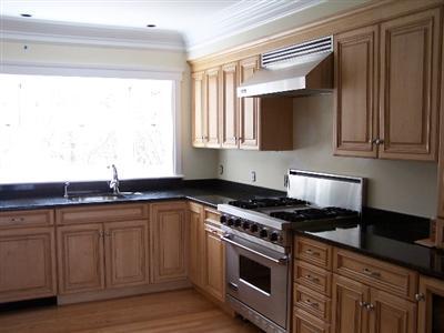 Undisclosed Address Falmouth, MA 02540 - Photo 4 of 6 a kitchen with stainless steel appliances granite countertop a sink stove and cabinets