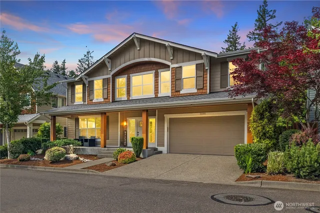 a front view of a house with garage and outdoor seating