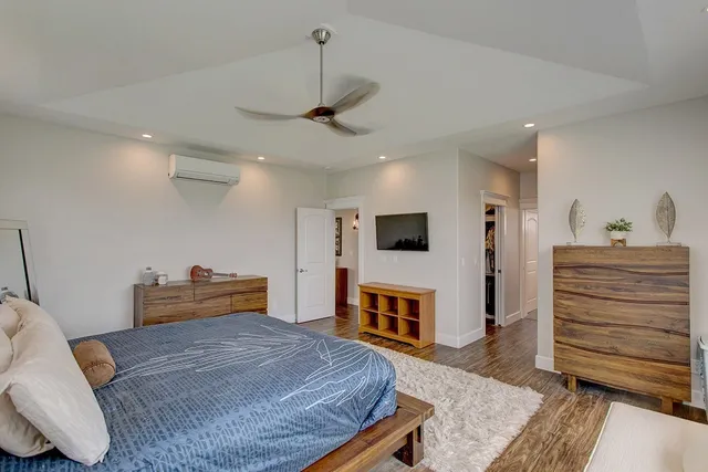 a bedroom with a bed and wooden floor