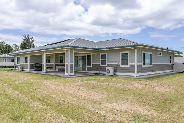 a view of a house with swimming pool and sitting area