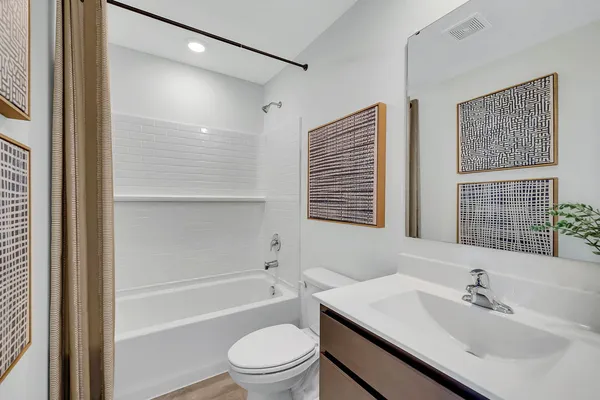 a bathroom with a sink toilet a mirror and shower