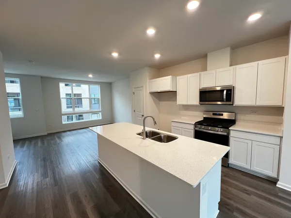 a kitchen with a sink stove and microwave