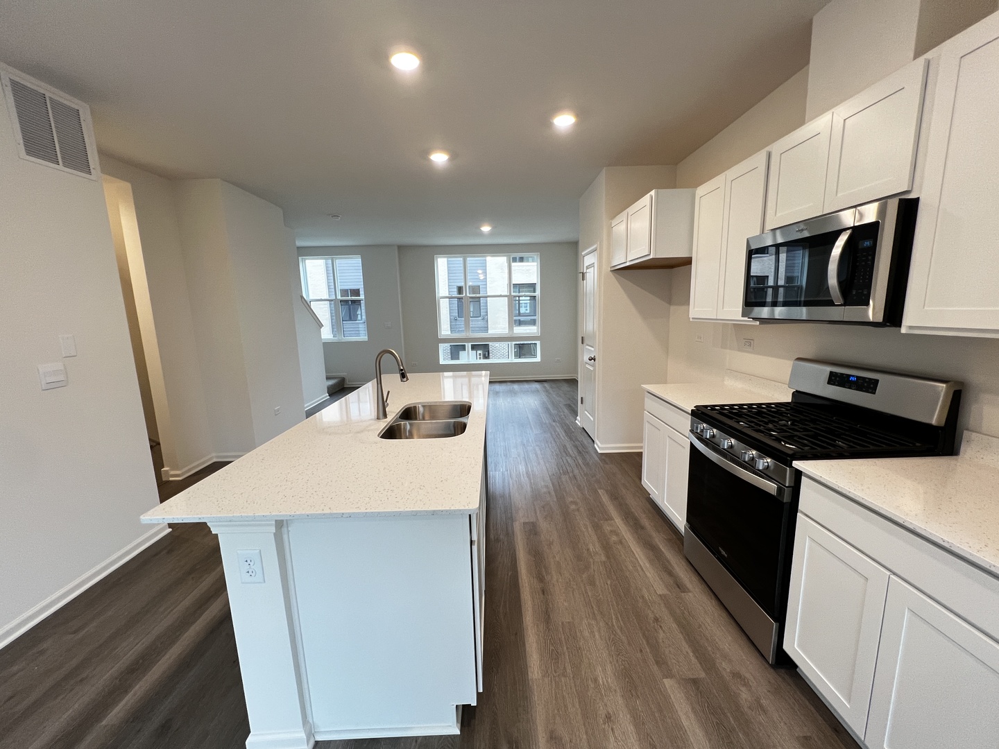 396 Summit Circle Lombard, IL 60148 - Photo 4 of 48 a kitchen with stainless steel appliances a microwave a sink a stove a refrigerator white cabinets and wooden floor