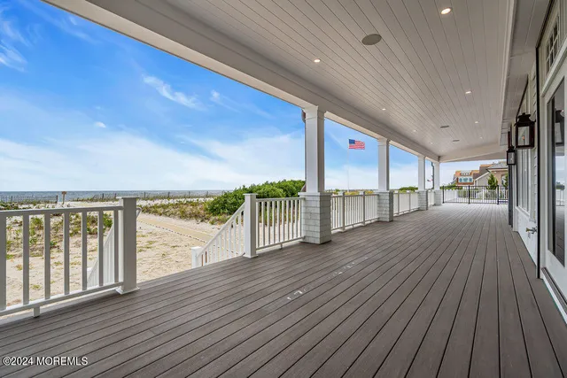 a view of a house with pool lawn chairs and wooden floor
