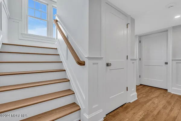 a bathroom with a toilet a sink a mirror and shower