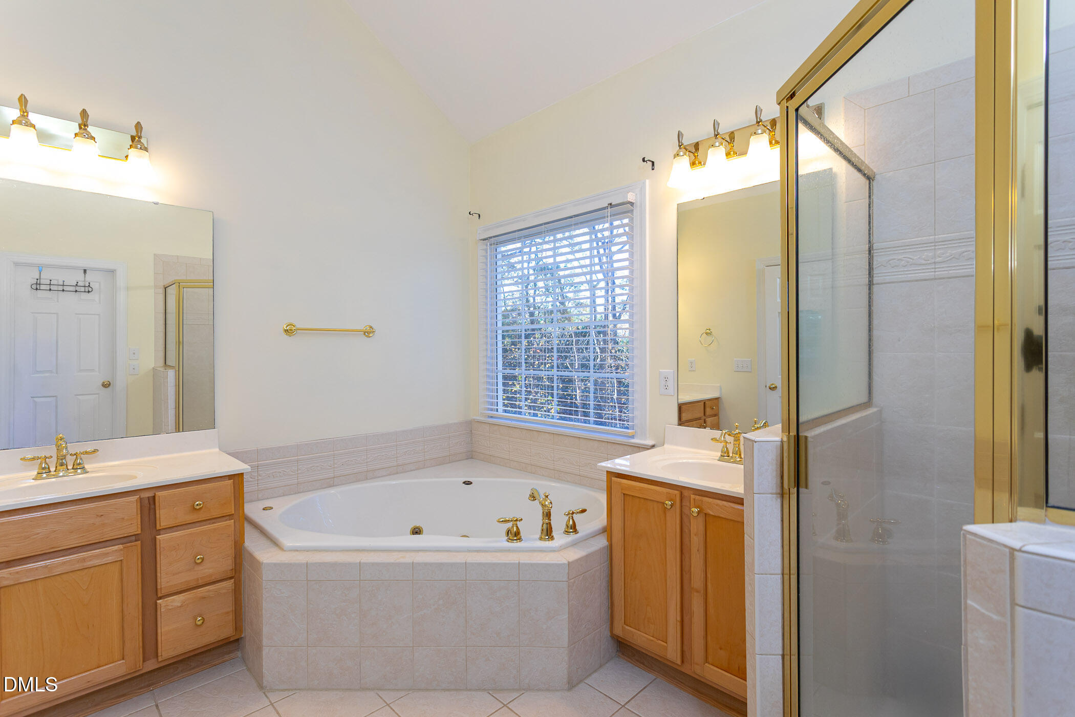 9409 Ray Road Raleigh, NC 27613 - Photo 16 of 47 a bathroom with a bathtub sink and mirror
