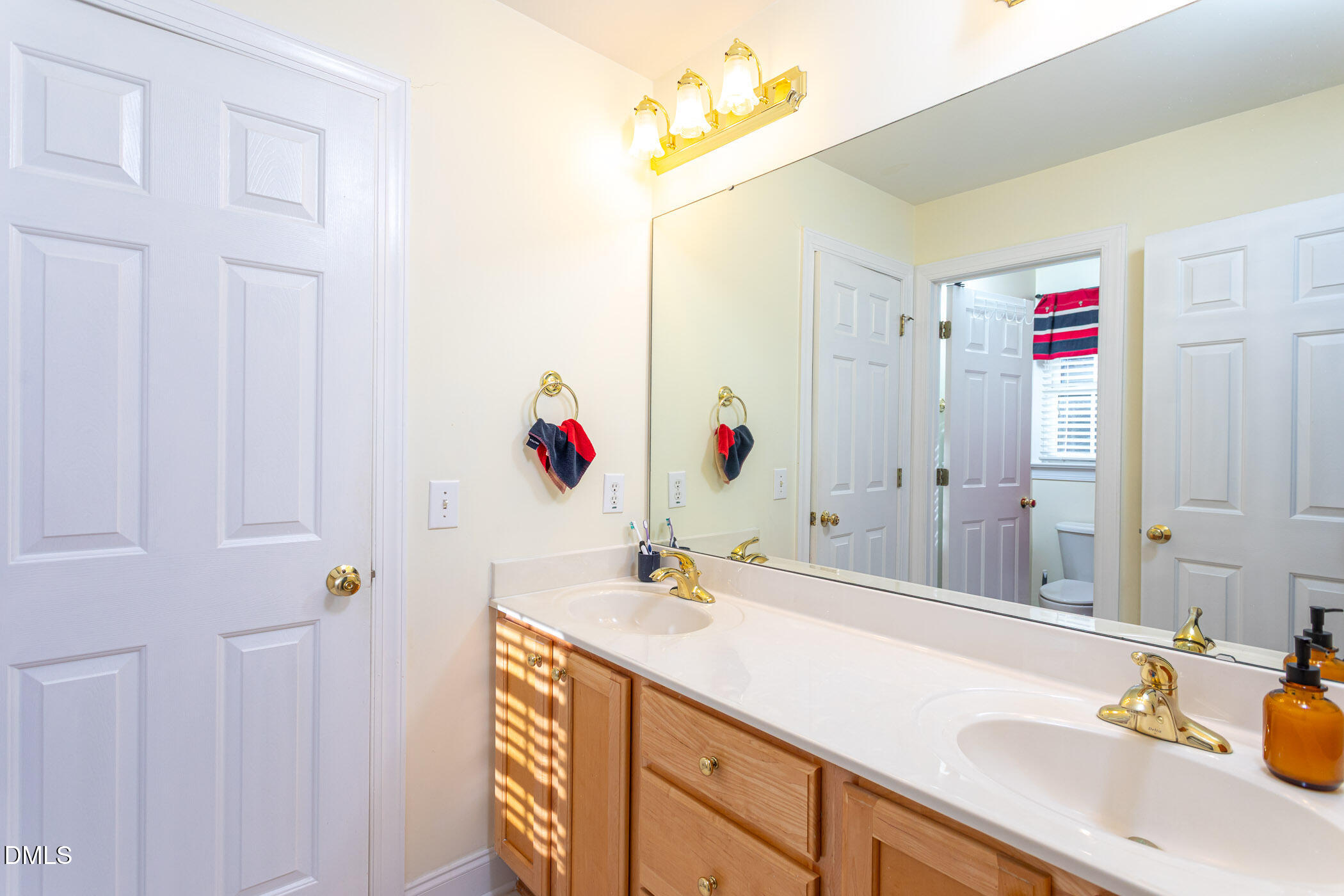 9409 Ray Road Raleigh, NC 27613 - Photo 21 of 47 a bathroom with a sink vanity and a mirror