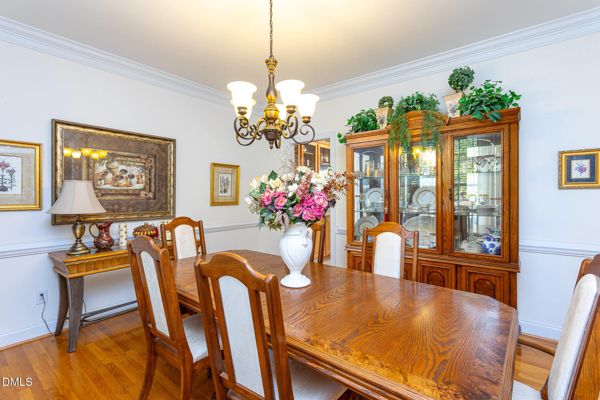 9409 Ray Road Raleigh, NC 27613 - Photo 4 of 47 a view of a dining room with furniture a chandelier and wooden floor