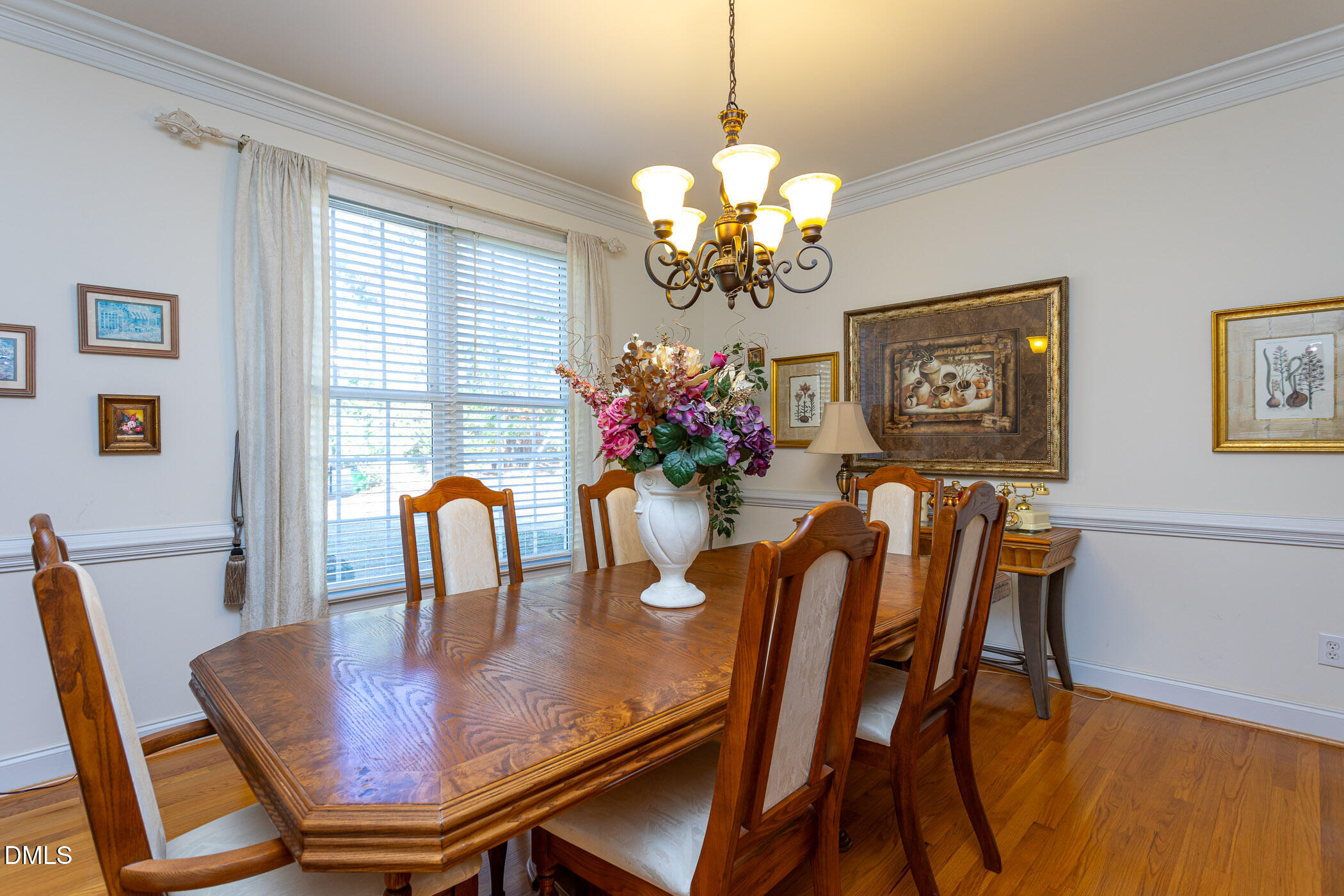 9409 Ray Road Raleigh, NC 27613 - Photo 5 of 47 a view of a dining room with furniture a chandelier and wooden floor