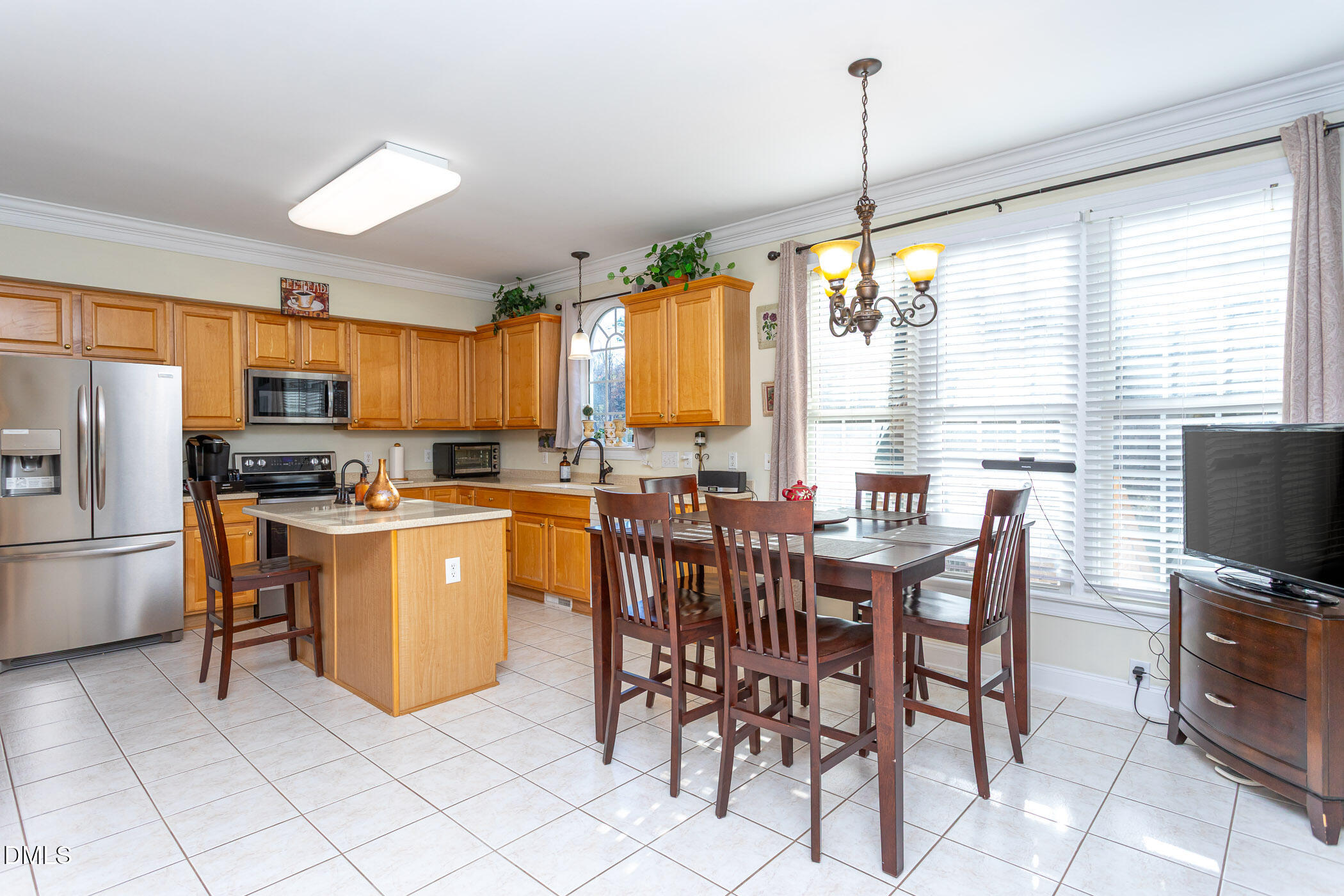 9409 Ray Road Raleigh, NC 27613 - Photo 10 of 47 a kitchen with appliances a window and dining table