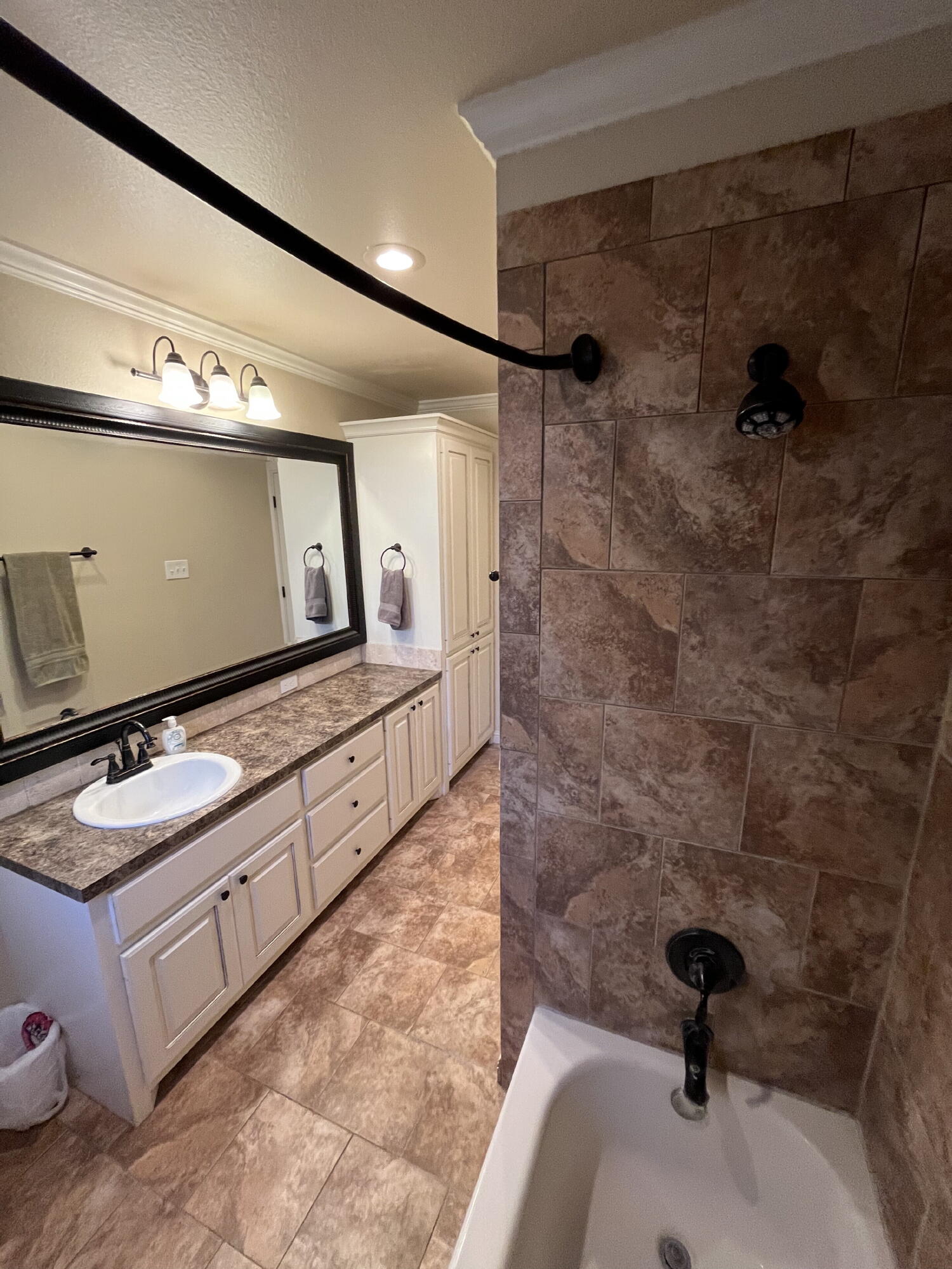 3321 55th Street Lubbock, TX 79413 - Photo 16 of 26 a bathroom with a double vanity sink and mirror