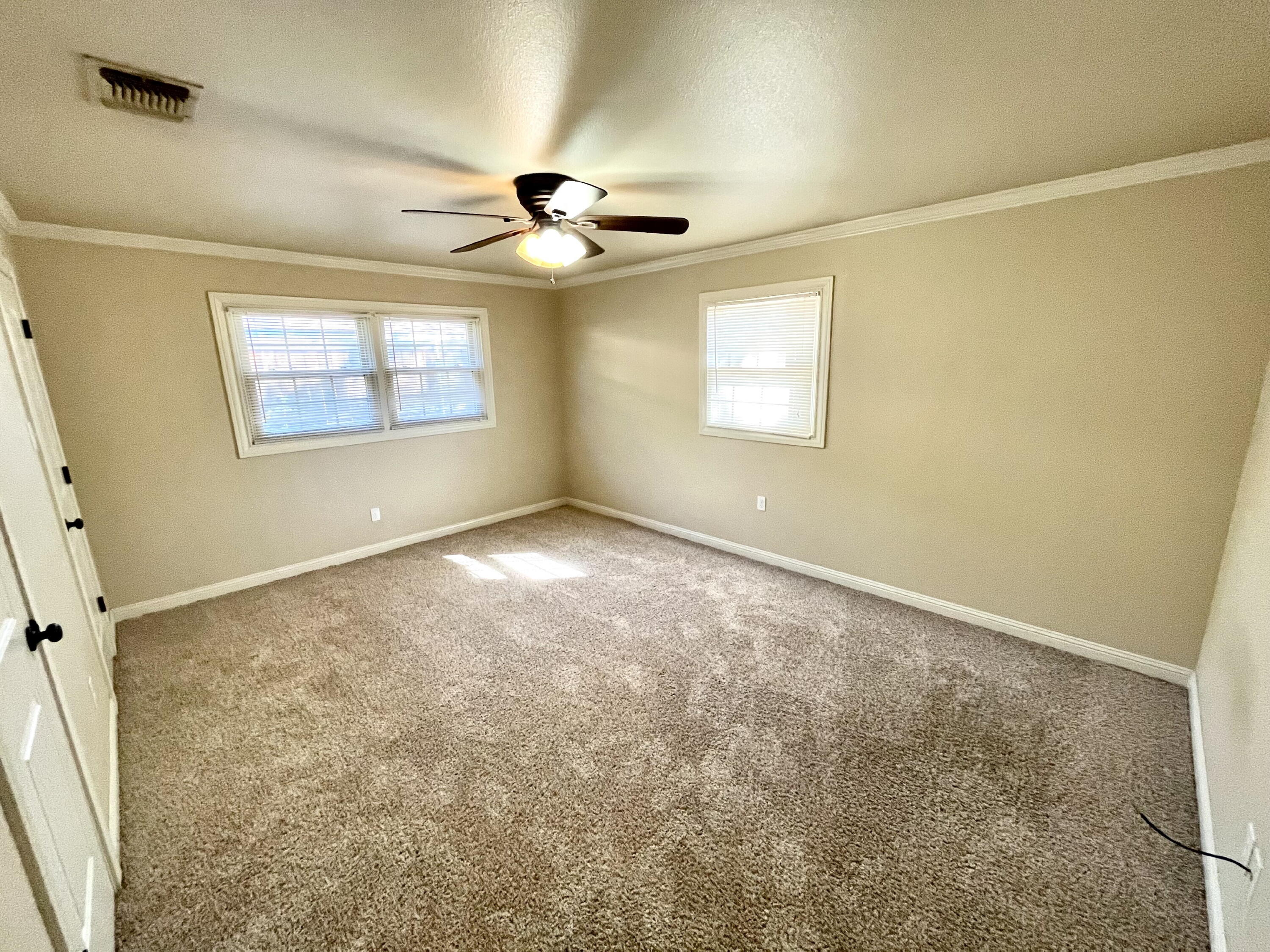 3321 55th Street Lubbock, TX 79413 - Photo 17 of 26 an empty room with windows and fan