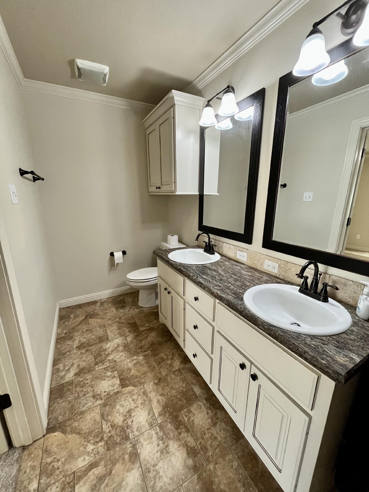 3321 55th Street Lubbock, TX 79413 - Photo 21 of 26 a bathroom with a double vanity sink and mirror