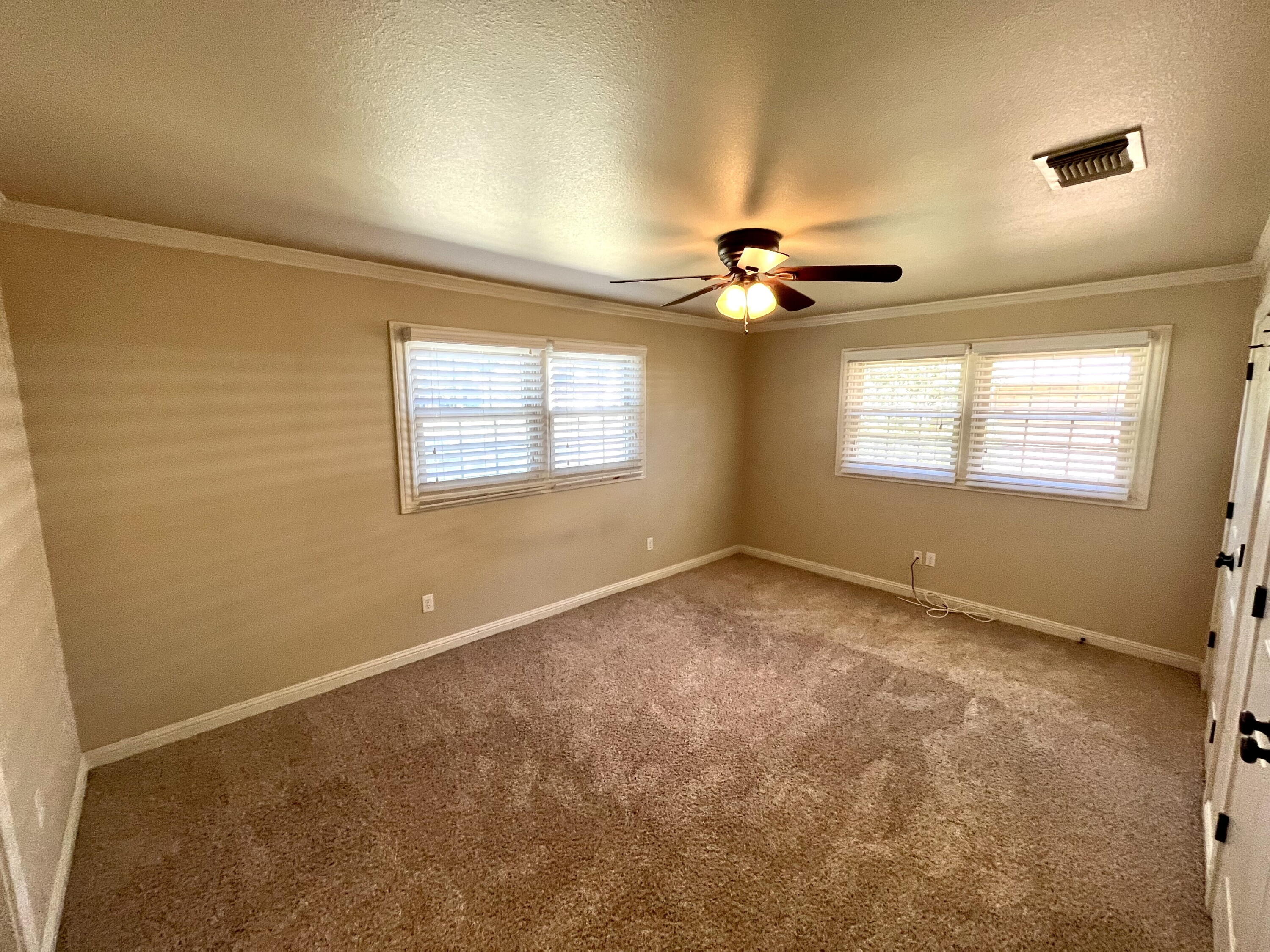 3321 55th Street Lubbock, TX 79413 - Photo 9 of 26 a view of a livingroom with a ceiling fan and window