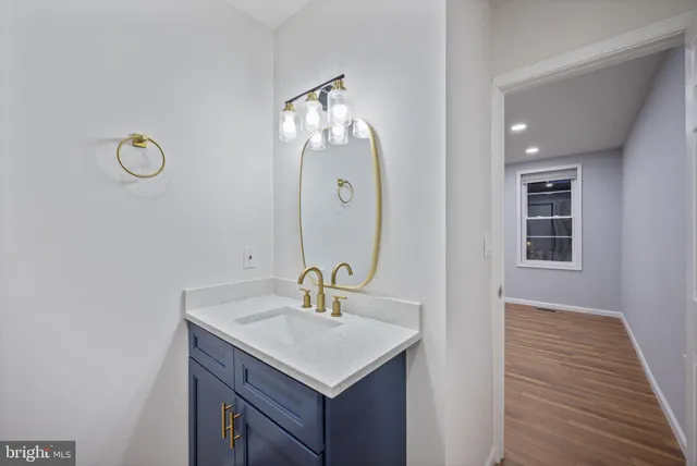 a bathroom with a sink vanity and mirror