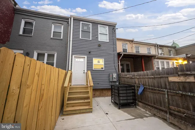a view of a house with wooden walls stairs