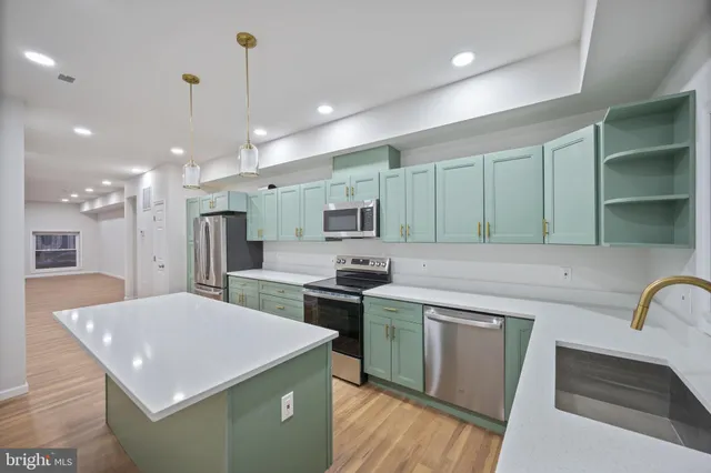 a kitchen with stainless steel appliances a sink stove and cabinets