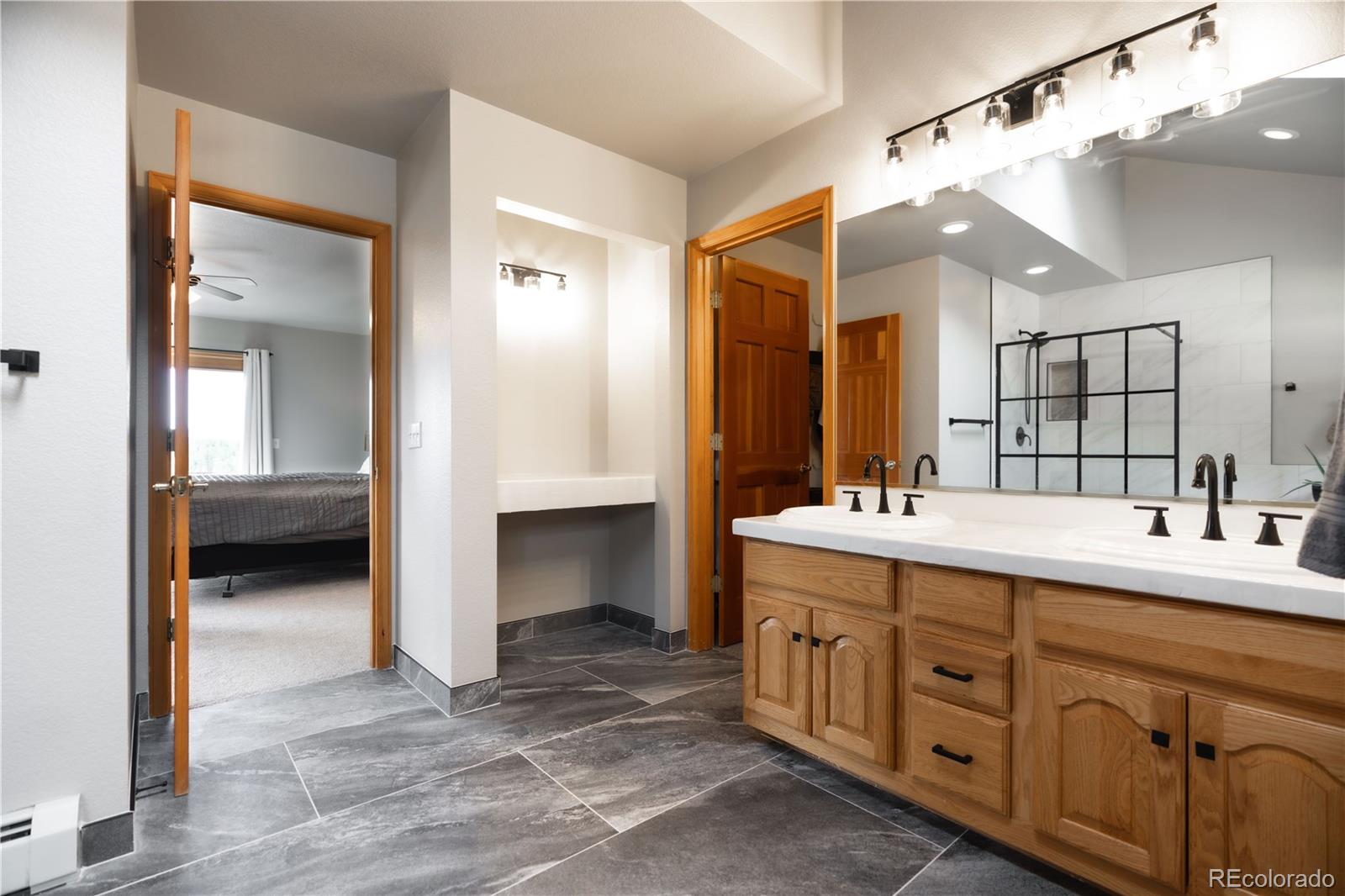 318 Rd D Pine, CO 80470 - Photo 27 of 50 a spacious bathroom with a double vanity sink and a mirror