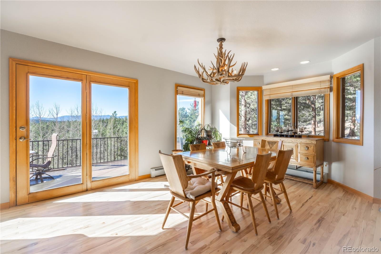 318 Rd D Pine, CO 80470 - Photo 34 of 50 a view of a dining room with furniture wooden floor and chandelier