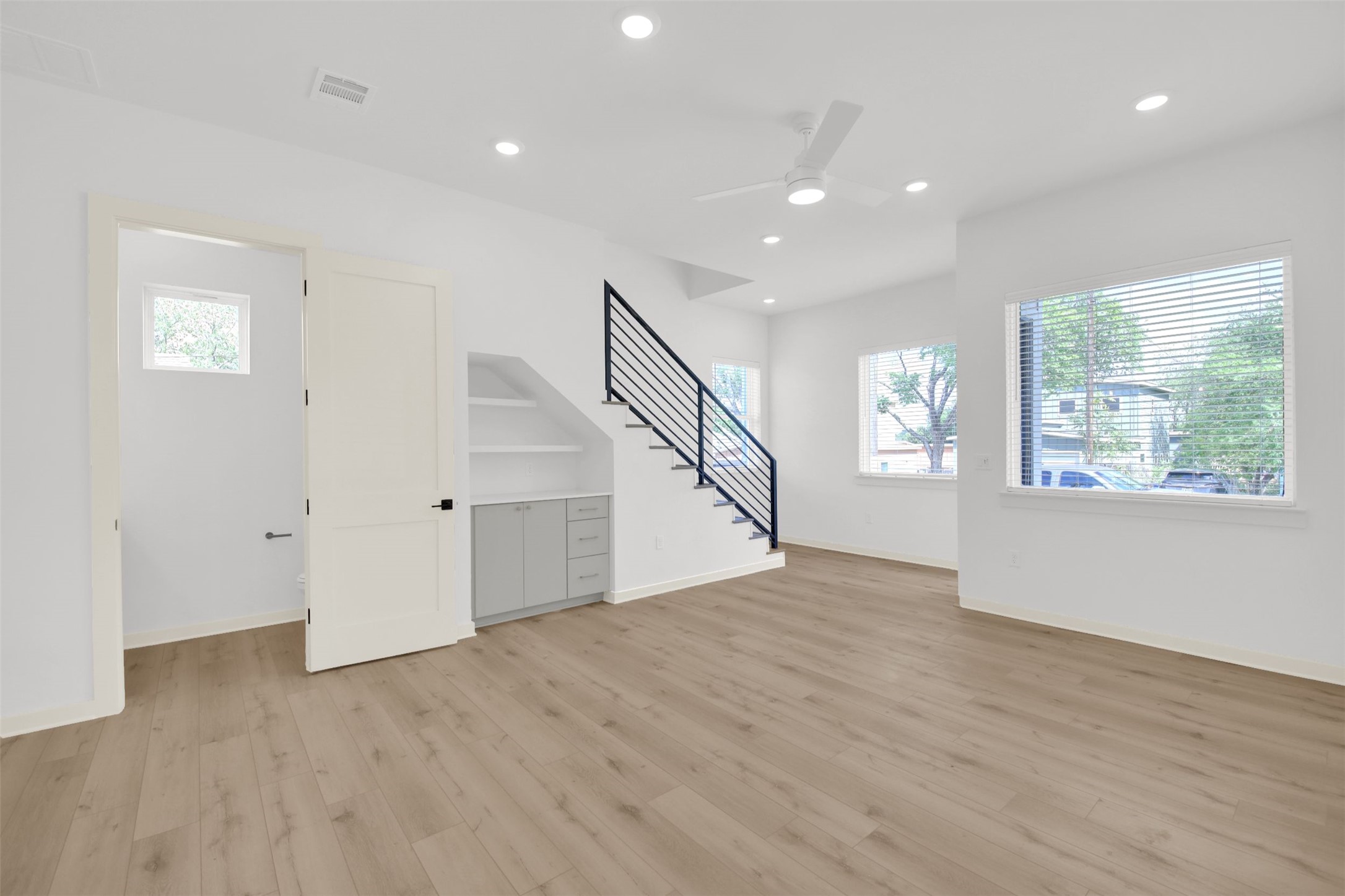 7208 Providence Avenue, Unit 1 Austin, TX 78752 - Photo 5 of 26 The property features wide plank flooring, recessed lighting, and a contemporary ceiling fan