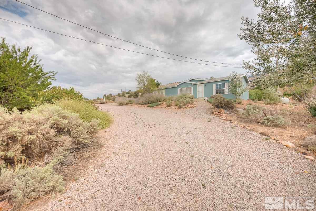 15186 Pinion Drive Reno, NV 89521 - Photo 1 of 20 a view of a dry yard with wooden fence