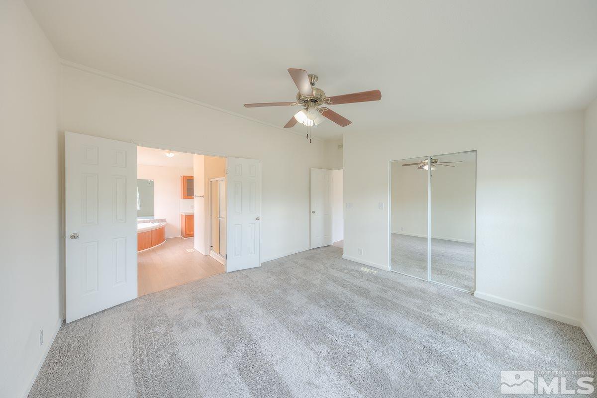 15186 Pinion Drive Reno, NV 89521 - Photo 12 of 20 a view of a big room with closet and a ceiling fan