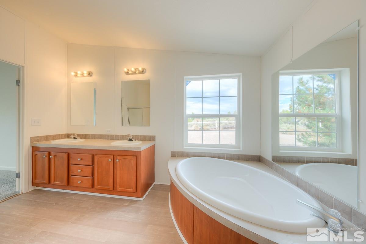 15186 Pinion Drive Reno, NV 89521 - Photo 13 of 20 a spacious bathroom with sink shower and bathtub