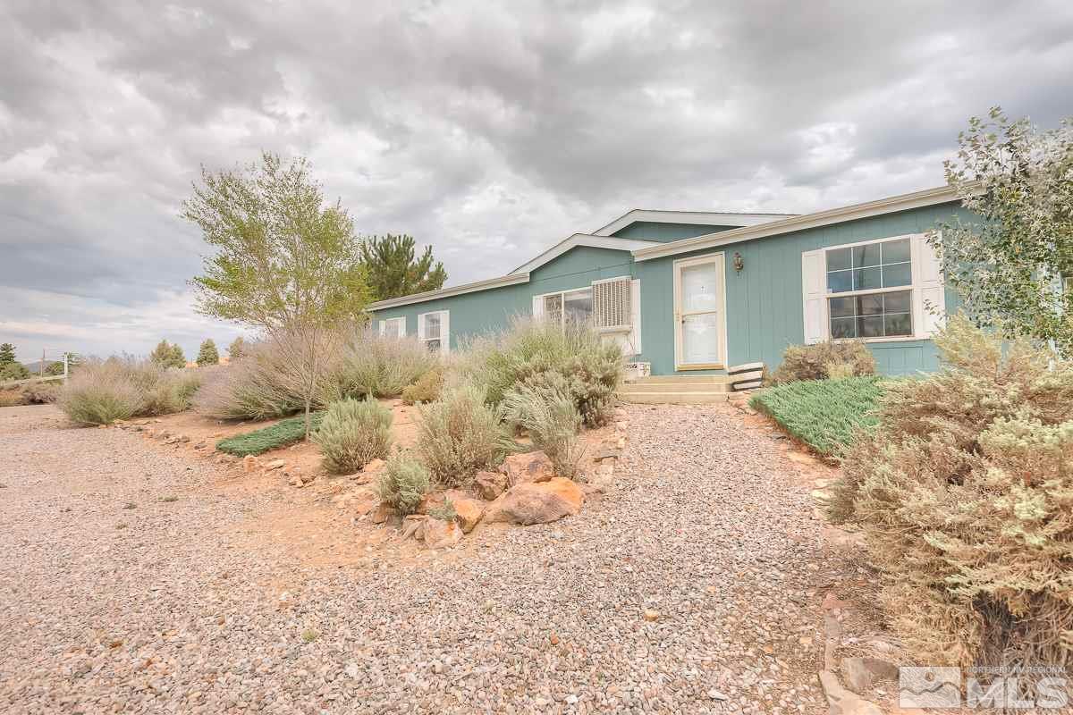 15186 Pinion Drive Reno, NV 89521 - Photo 2 of 20 a front view of a house with a yard and garage