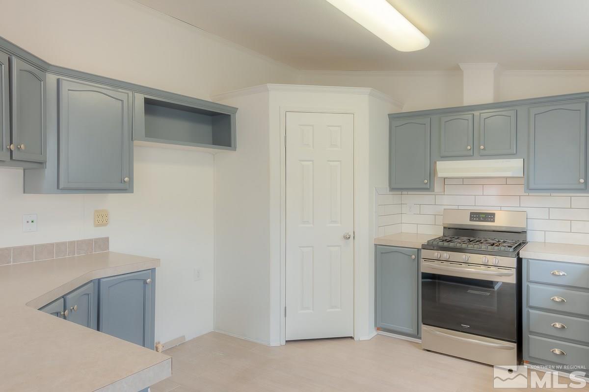 15186 Pinion Drive Reno, NV 89521 - Photo 10 of 20 a kitchen with cabinets and steel appliances