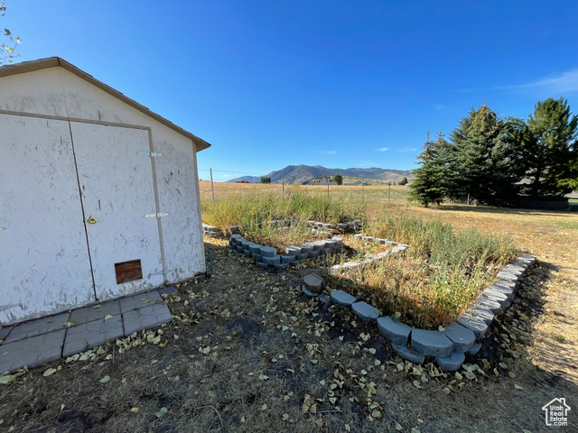 11473 South Dempsey Creek Road Lava Hot Springs, ID 83246 - Photo 36 of 47 View of yard with a mountain view, a view of rural / pastoral area, and a shed