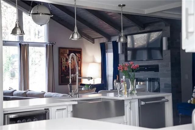 a kitchen with stainless steel appliances granite countertop a sink and cabinets