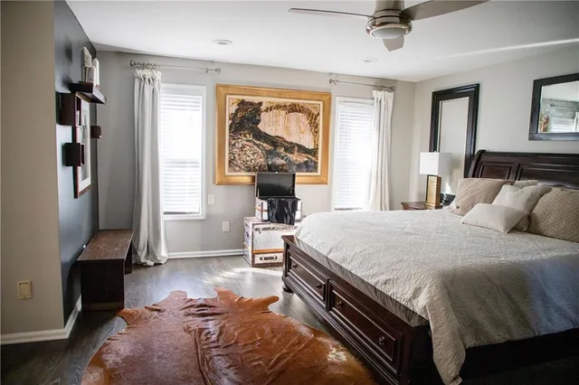a bed sitting in a bedroom next to a window