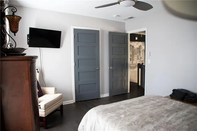 a bedroom with a bed and a television