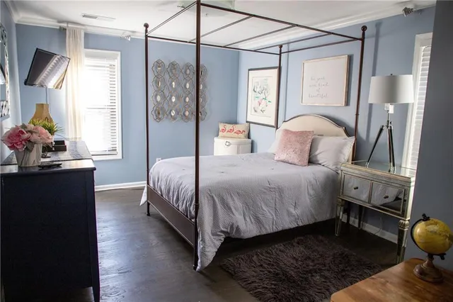a bedroom with a bed and wooden floor